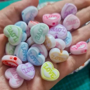Love heart beads with LOVE text printed in different colors for jewelry making