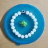 matte white evil eye beaded bracelet with turtle charm