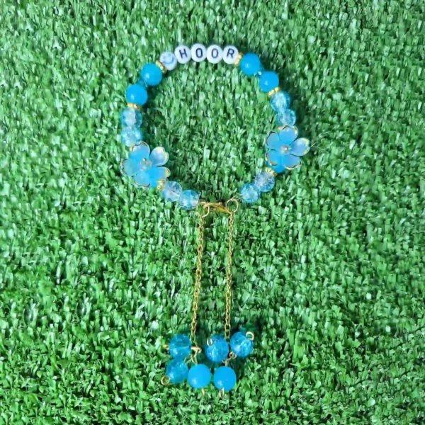Blue personalized name bracelet with flower charm and hanging bead chain