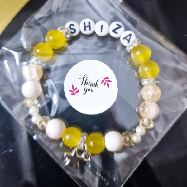 Personalized yellow Luxe Bracelet with custom names in thank you packaging
