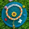 Personalized kids name bracelet with turtle charms and daisy - handmade by The Beading Sisters
