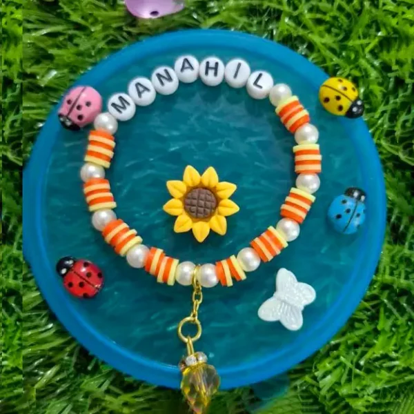 Personalized kids name bracelet with turtle charms and daisy - handmade by The Beading Sisters